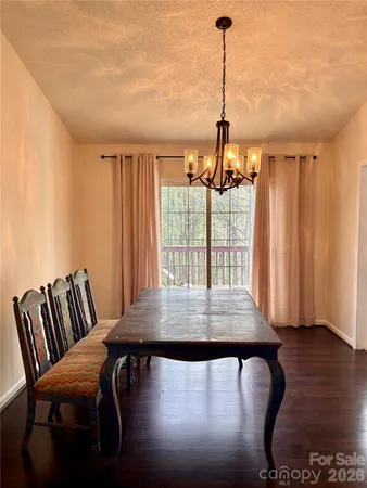 a view of a room with furniture and wooden floor