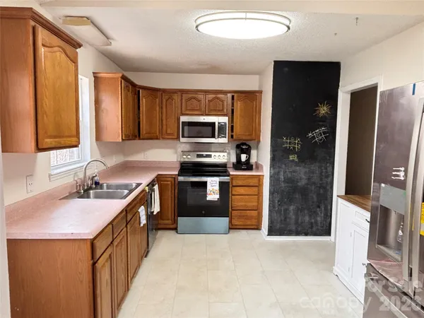 a kitchen with a sink stove and refrigerator