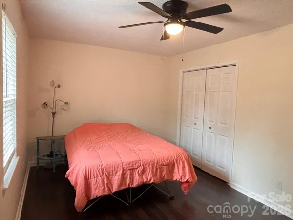 a bed room with a bed and a ceiling fan