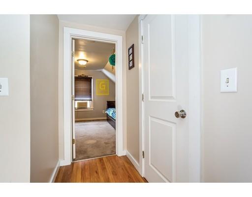 159 Powell Avenue Springfield, MA 01118 - Photo 16 of 30 a view of a hallway with wooden floor and a livingroom