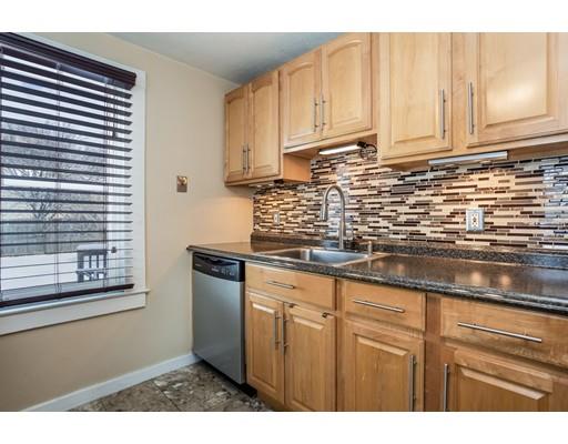 159 Powell Avenue Springfield, MA 01118 - Photo 8 of 30 a kitchen with stainless steel appliances granite countertop a sink a stove and white cabinets