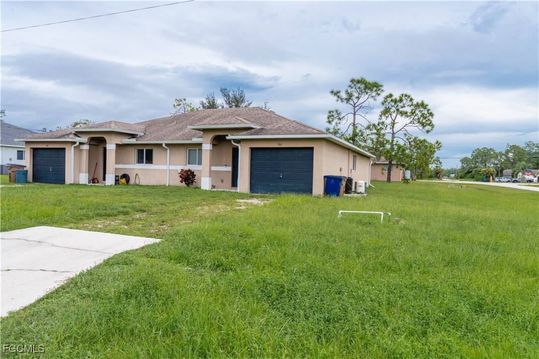 a front view of house with yard and green space