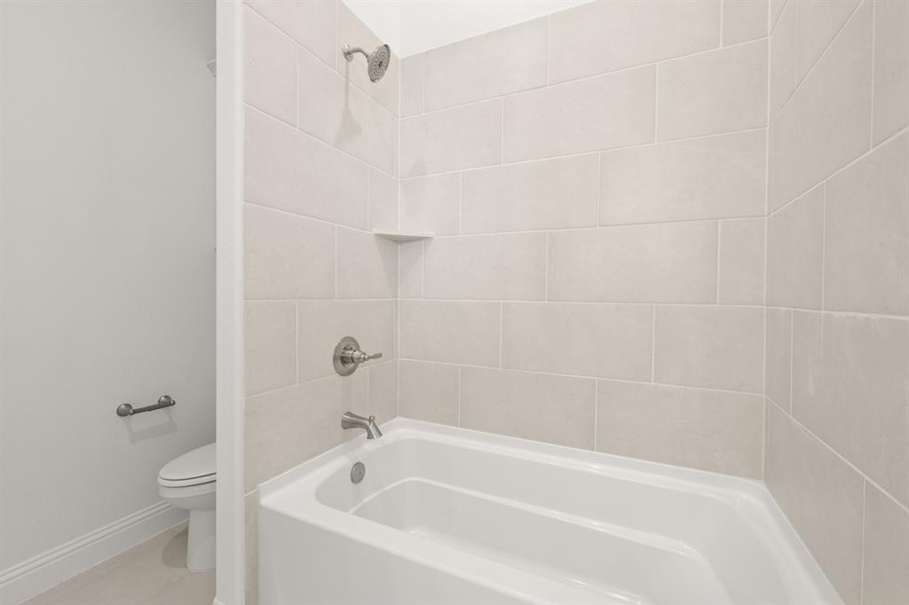 27 Old Crow Road Joshua, TX 76058 - Photo 20 of 35 a white bath tub sitting next to a white toilet and sink