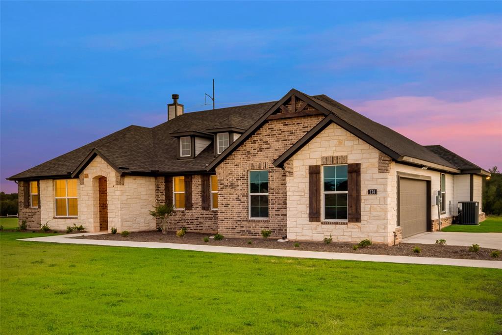 174 Chester Road Springtown, TX 76082 - Photo 1 of 1 a front view of a house with a yard