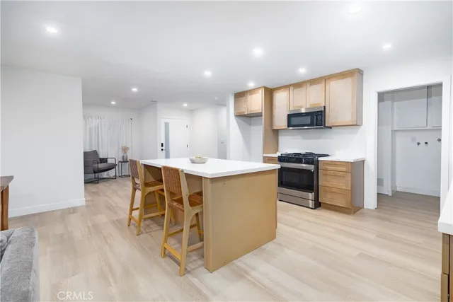 a kitchen with stainless steel appliances granite countertop a stove and a refrigerator