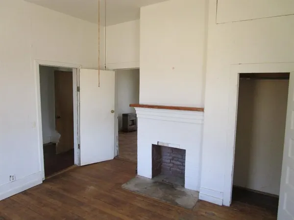 a view of a livingroom with an empty space and a fireplace