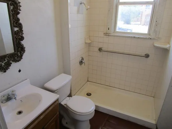 a bathroom with a sink toilet and shower
