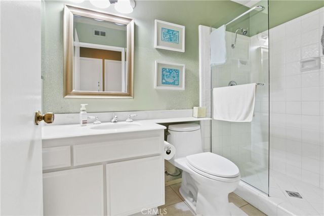 a bathroom with a sink toilet vanity and shower