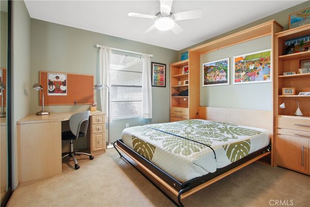 a bedroom with a bed and cabinets