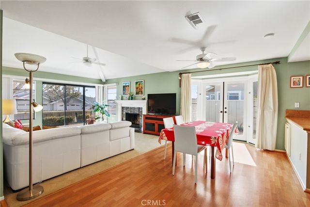 a living room with furniture a flat screen tv and a large window