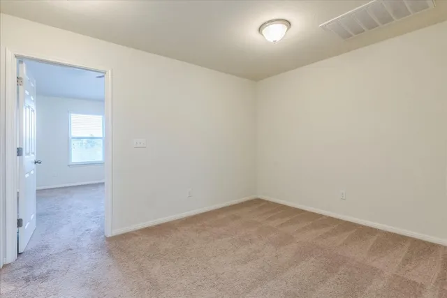 an empty room with a empty space and windows