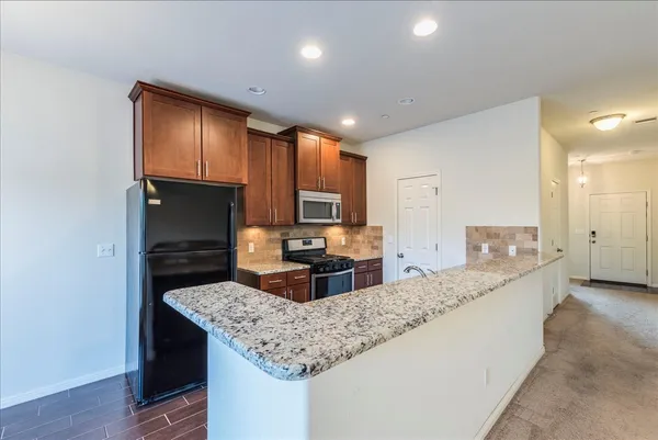 a kitchen with kitchen island granite countertop a sink and counter space