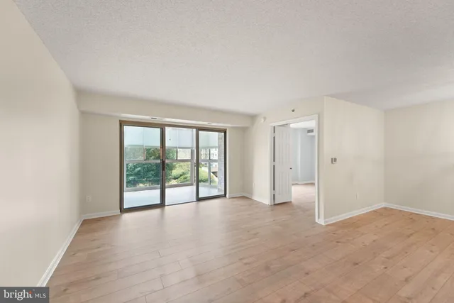 a view of an empty room with glass door