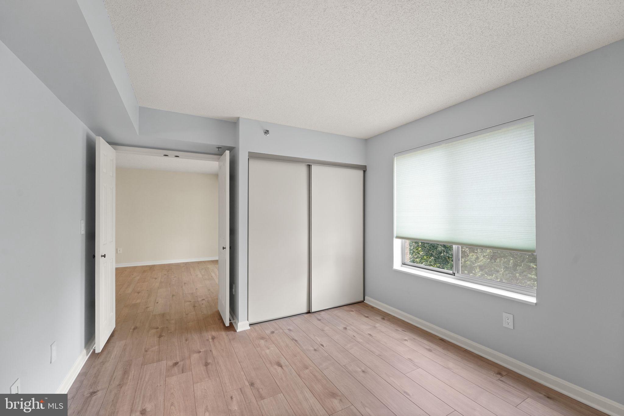 19385 Cypress Ridge Terrace, Unit 522 Leesburg, VA 20176 - Photo 18 of 33 an empty room with wooden floor and windows