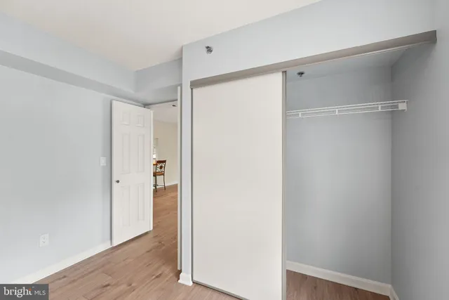 a view of closet area with wooden floor