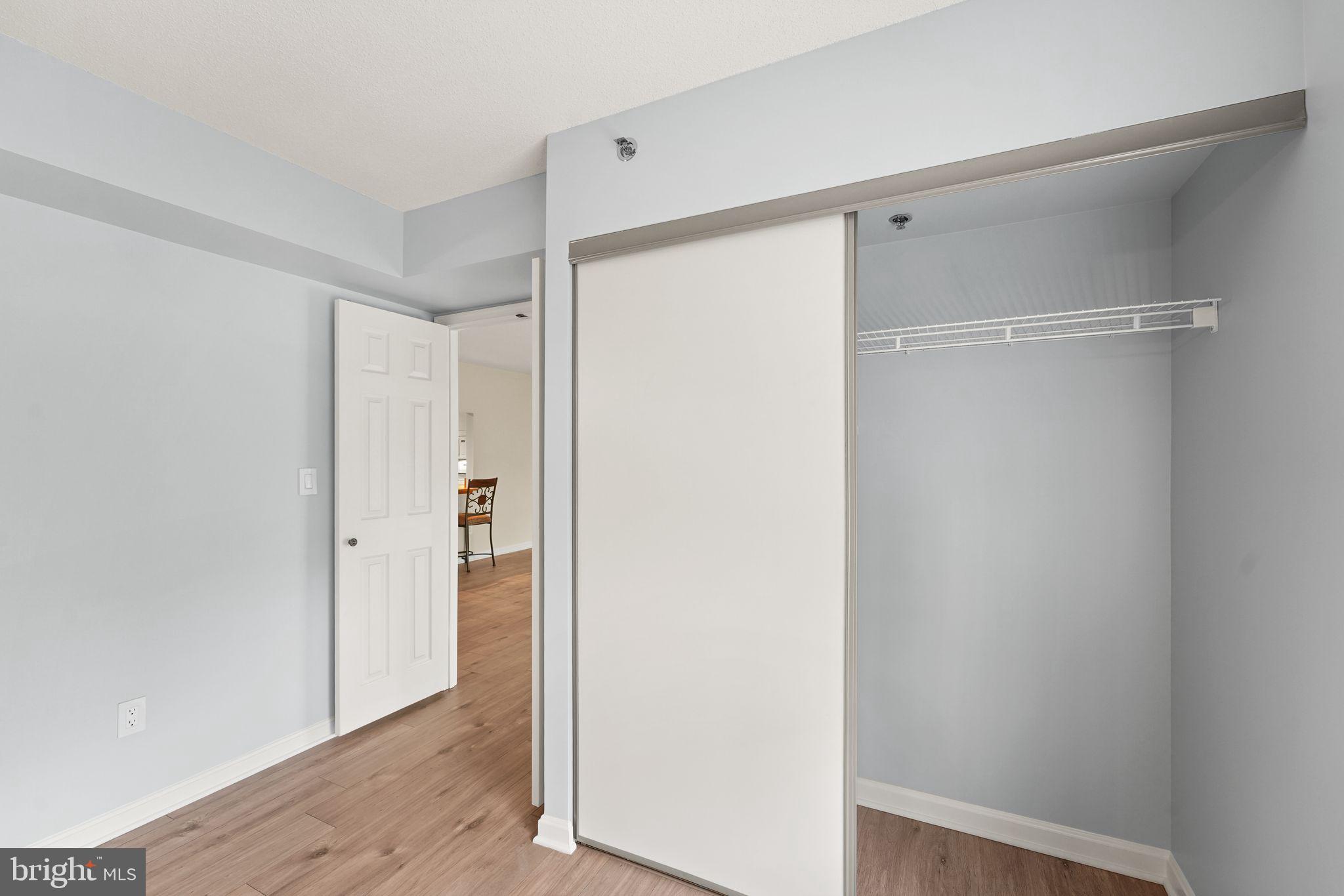 19385 Cypress Ridge Terrace, Unit 522 Leesburg, VA 20176 - Photo 19 of 33 a view of closet area with wooden floor