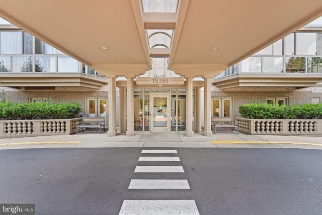 a front view of a building with a fountain