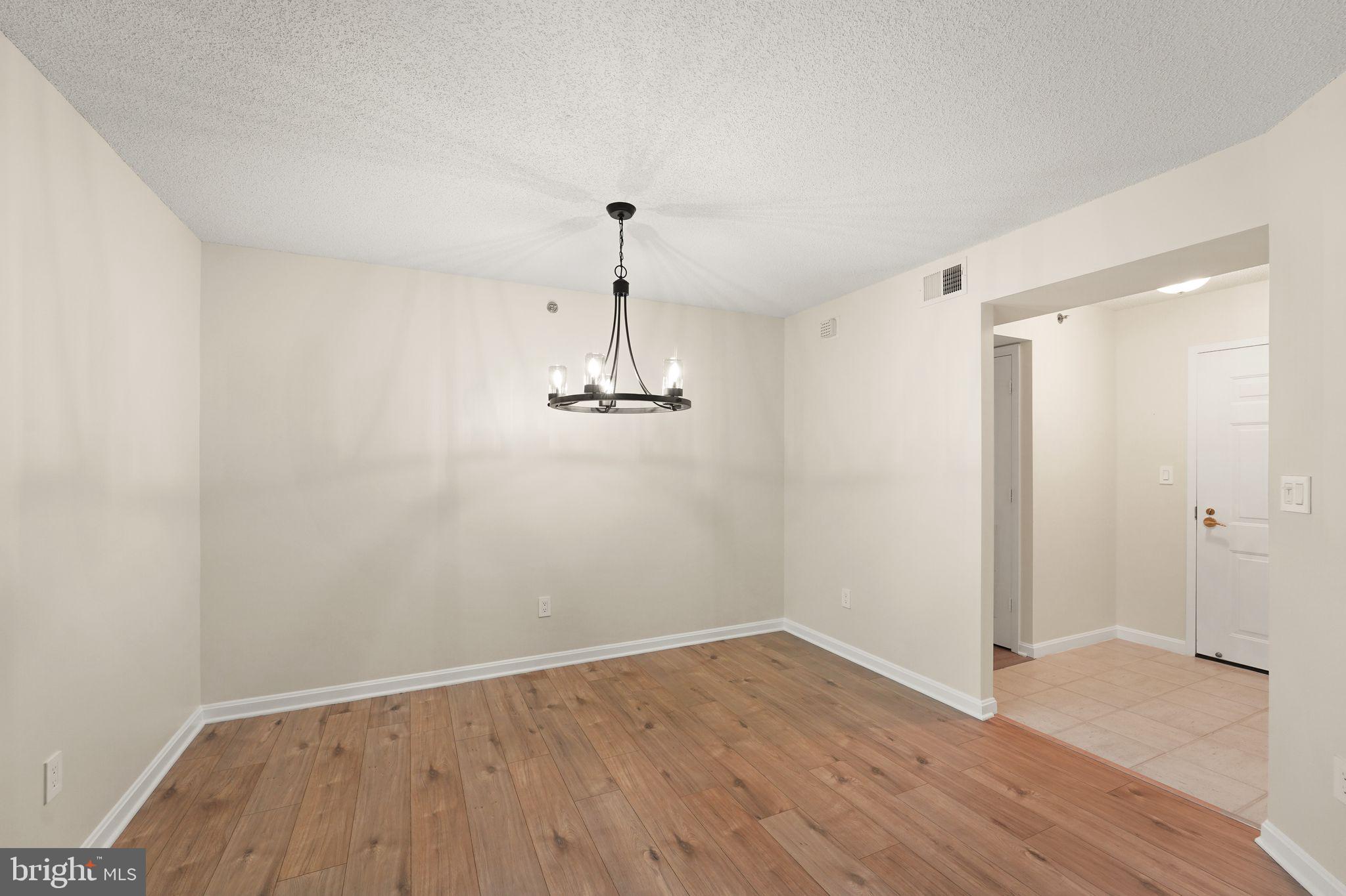 19385 Cypress Ridge Terrace, Unit 522 Leesburg, VA 20176 - Photo 21 of 33 a view of empty room with wooden floor