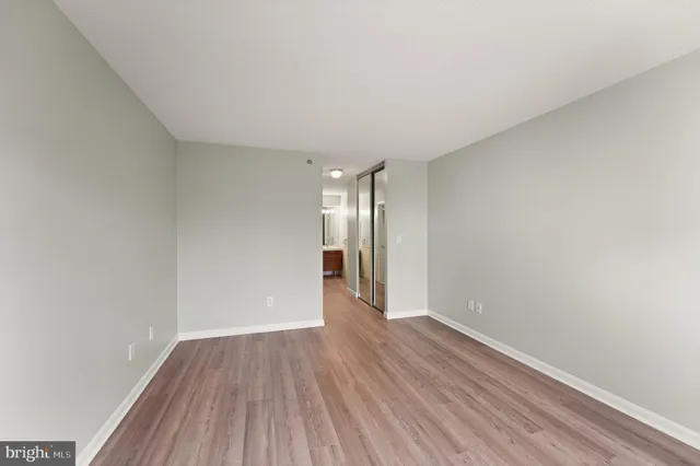a view of an empty room and wooden floor