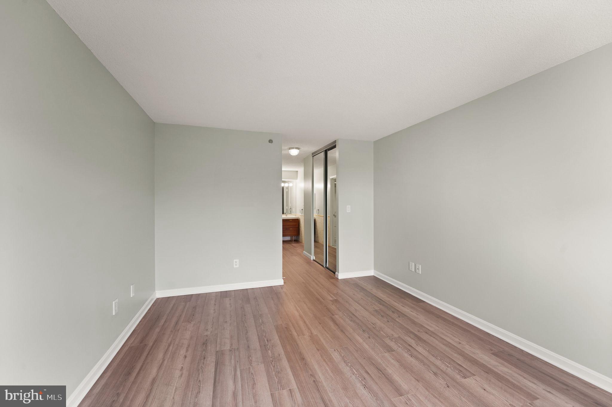19385 Cypress Ridge Terrace, Unit 522 Leesburg, VA 20176 - Photo 24 of 33 a view of an empty room and wooden floor