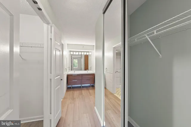 a view of walk in closet with empty racks