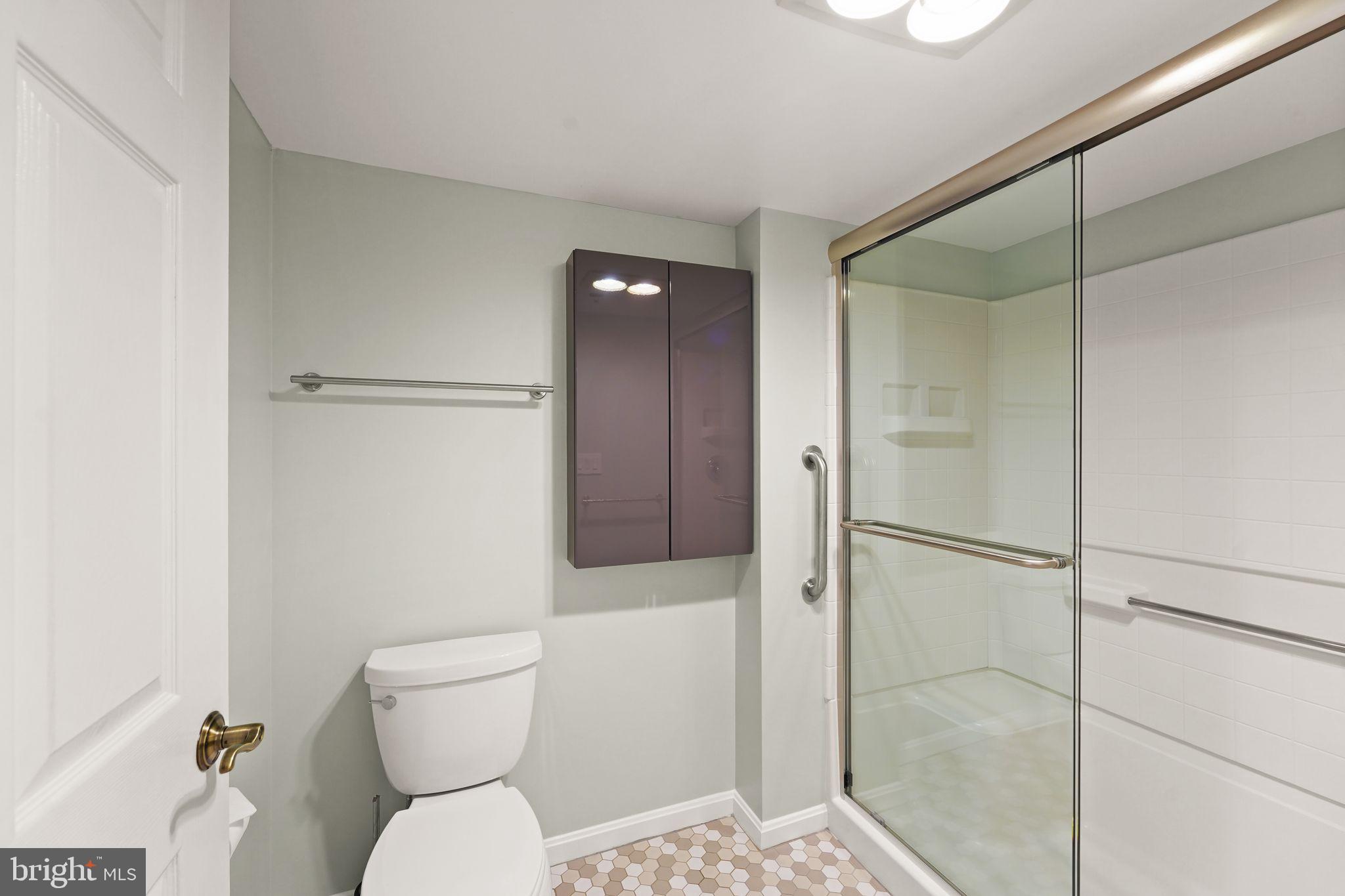 19385 Cypress Ridge Terrace, Unit 522 Leesburg, VA 20176 - Photo 28 of 33 a white toilet sitting next to a bathroom sink