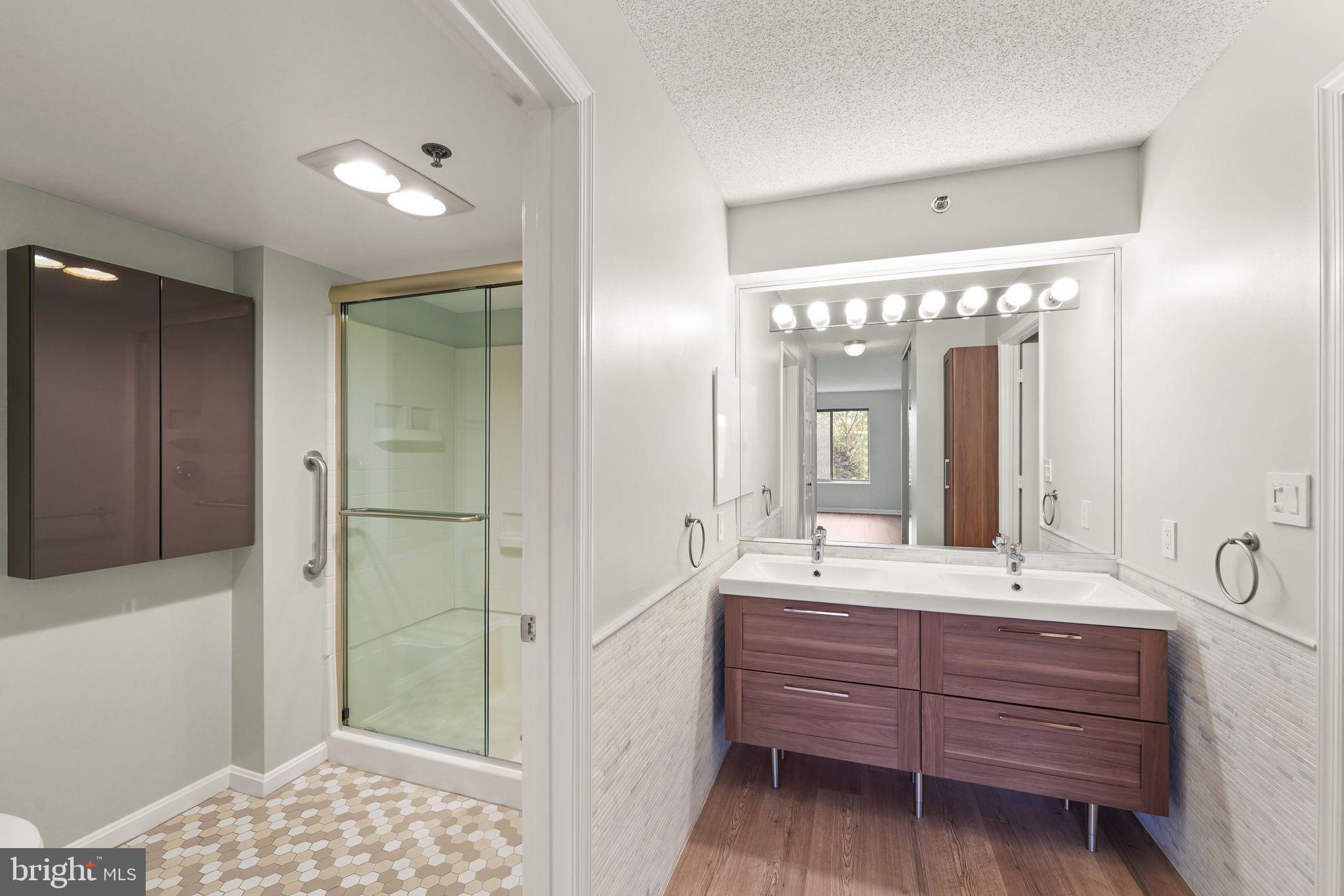 19385 Cypress Ridge Terrace, Unit 522 Leesburg, VA 20176 - Photo 29 of 33 a bathroom with a sink and a mirror
