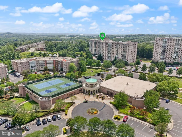 a view of a city with lush green forest