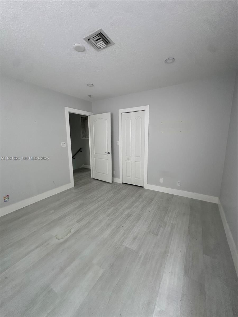 354 Mallard Road, Unit O Weston, FL 33327 - Photo 17 of 29 a view of an empty room with wooden floor