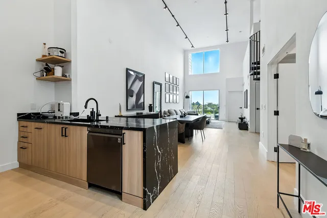 a kitchen with sink refrigerator and cabinets