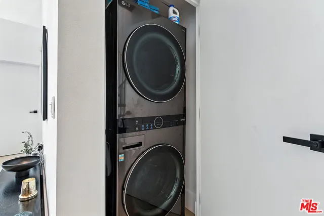 a close view of a utility room with dryer and washer