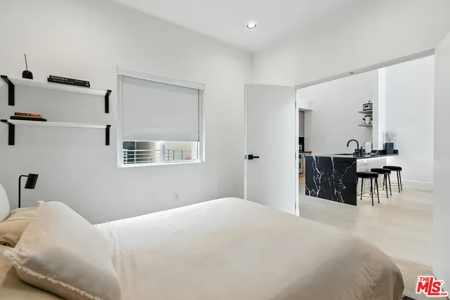 a bedroom with a bed and a table