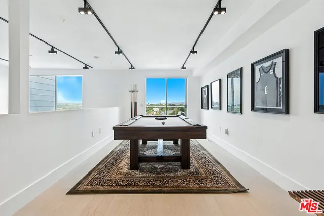 a view of a room with furniture and wooden floor