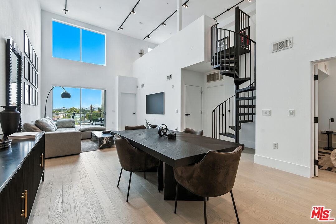 4211 Redwood Avenue, Unit 402 Los Angeles, CA 90066 - Photo 3 of 33 a living room with dining table and wooden floor