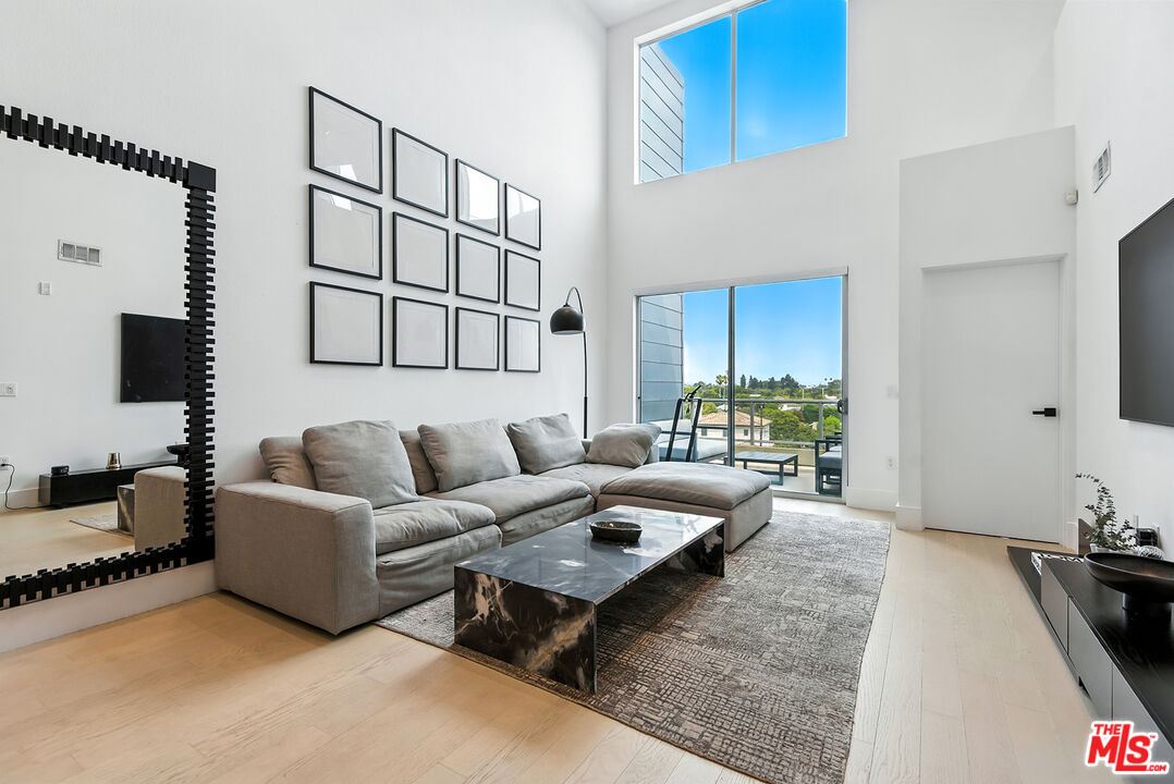 4211 Redwood Avenue, Unit 402 Los Angeles, CA 90066 - Photo 4 of 33 a living room with furniture and a flat screen tv