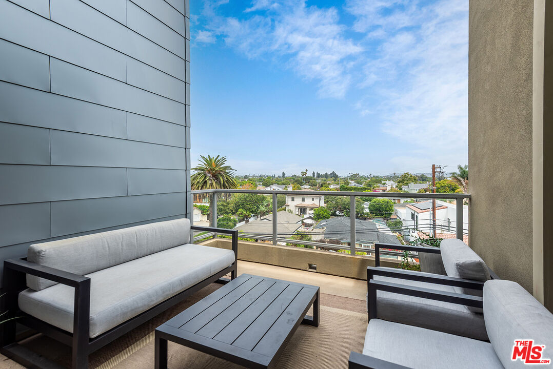 4211 Redwood Avenue, Unit 402 Los Angeles, CA 90066 - Photo 6 of 33 a balcony with wooden floor and city view