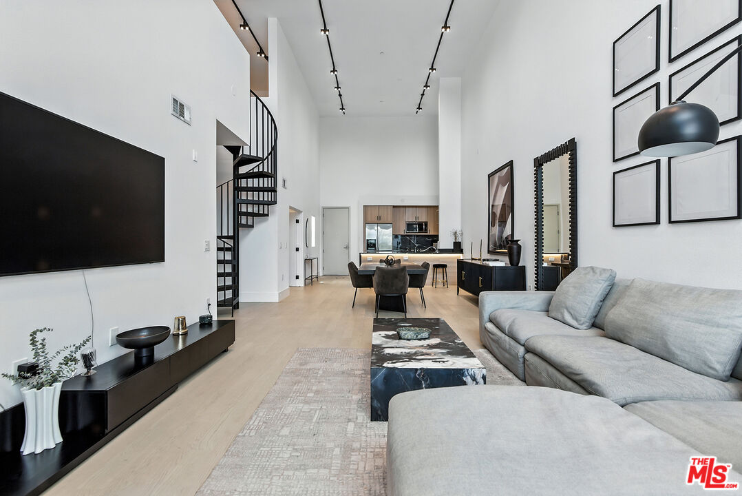4211 Redwood Avenue, Unit 402 Los Angeles, CA 90066 - Photo 9 of 33 a living room with furniture and a flat screen tv