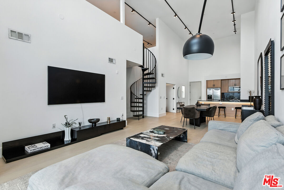 4211 Redwood Avenue, Unit 402 Los Angeles, CA 90066 - Photo 10 of 33 a living room with furniture and a flat screen tv