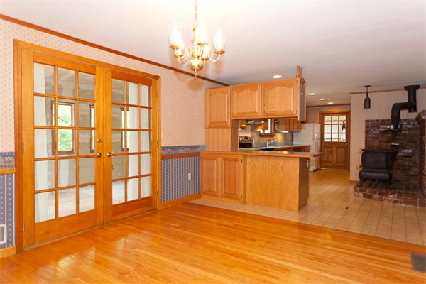 66 Baker Road Salisbury, MA 01952 - Photo 12 of 22 a view of a living room and kitchen with stainless steel appliances wooden floor and large window