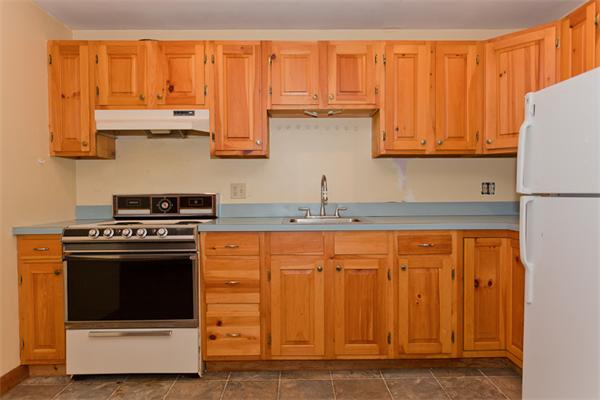 66 Baker Road Salisbury, MA 01952 - Photo 19 of 22 a kitchen with stainless steel appliances granite countertop a stove and a refrigerator with white cabinets