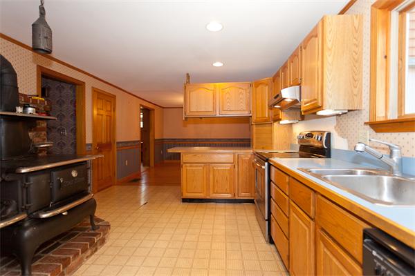 66 Baker Road Salisbury, MA 01952 - Photo 3 of 22 a kitchen with wooden cabinets and a sink