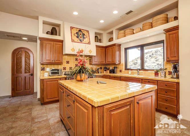 72275 Upper Way West Palm Desert, CA 92260 - Photo 42 of 90 a kitchen with stainless steel appliances granite countertop a stove and a sink