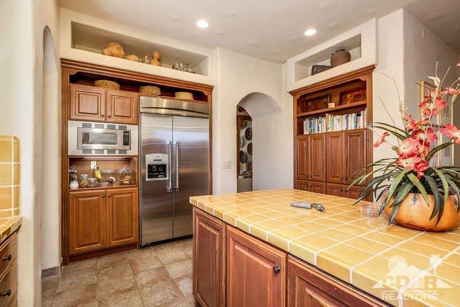 72275 Upper Way West Palm Desert, CA 92260 - Photo 45 of 90 a kitchen with stainless steel appliances kitchen island granite countertop a refrigerator and a stove
