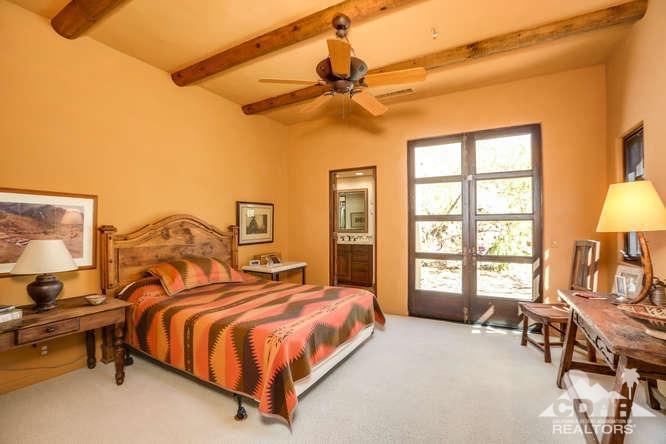 72275 Upper Way West Palm Desert, CA 92260 - Photo 47 of 90 a spacious bedroom with a bed a dresser and a window