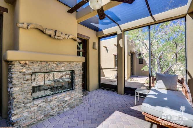 72275 Upper Way West Palm Desert, CA 92260 - Photo 56 of 90 a living room with furniture a fireplace and a floor to ceiling window