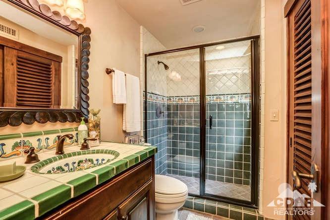 72275 Upper Way West Palm Desert, CA 92260 - Photo 60 of 90 a bathroom with a granite countertop sink a toilet and shower