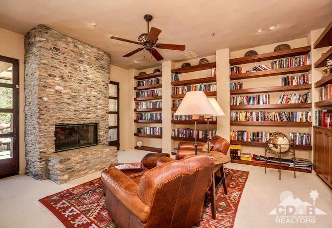 72275 Upper Way West Palm Desert, CA 92260 - Photo 61 of 90 a living room with furniture a fireplace and a book shelf
