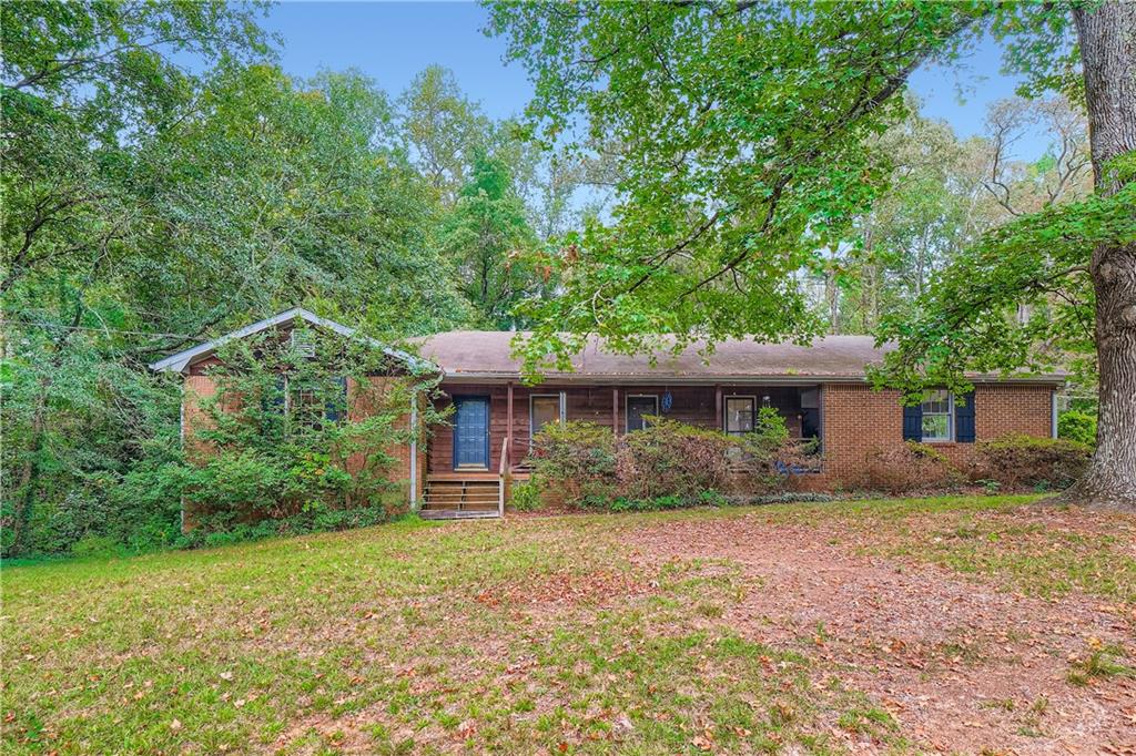 642 Sheppard Road Stone Mountain, GA 30083 - Photo 1 of 1 front view of a house with a yard