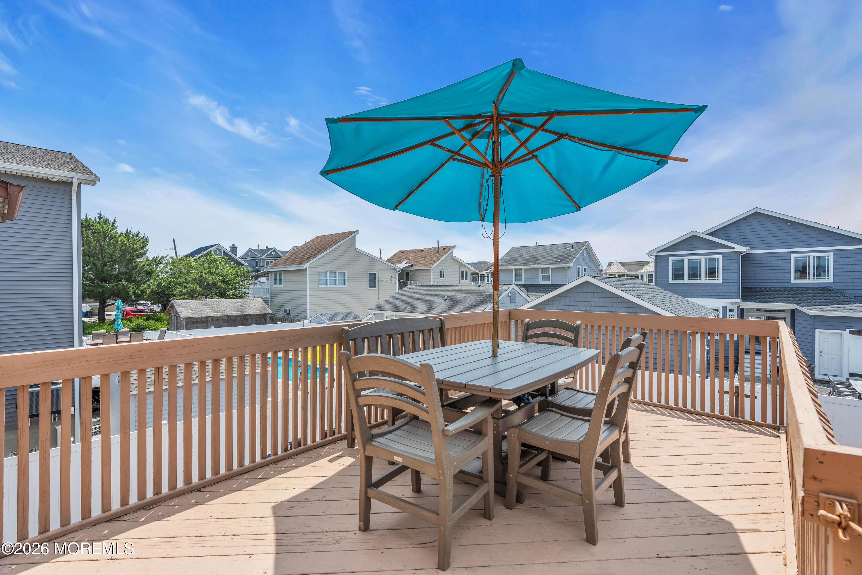8 President Avenue, Unit 1 Lavallette, NJ 08735 - Photo 15 of 18 a view of a roof deck with table and chairs under an umbrella