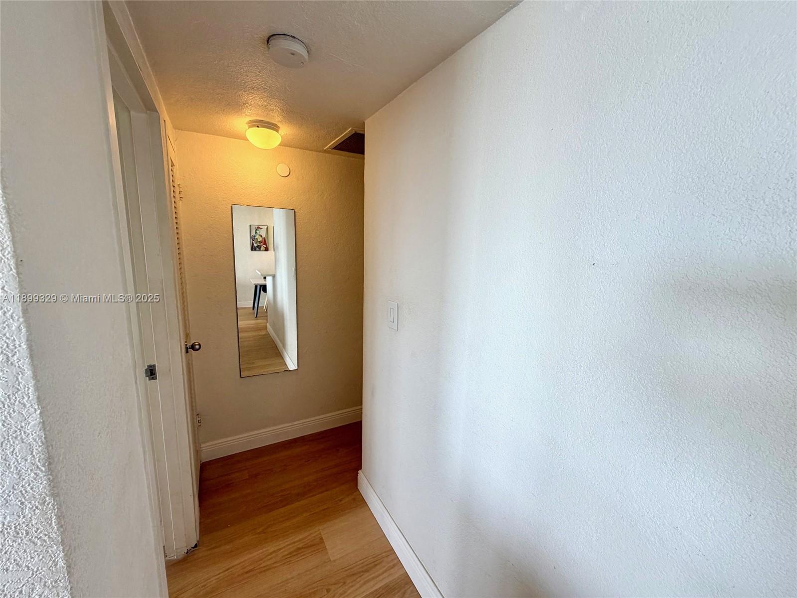 1500 Bay Road, Unit 1274S Miami Beach, FL 33139 - Photo 11 of 36 a view of a hallway with wooden floor